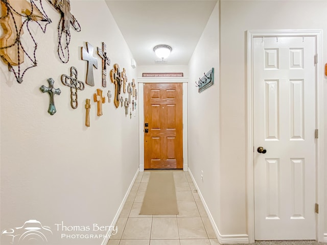 doorway with light tile patterned floors