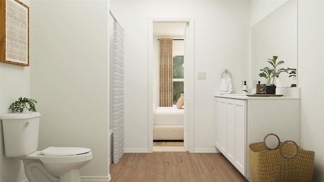 bathroom with vanity, hardwood / wood-style floors, and toilet