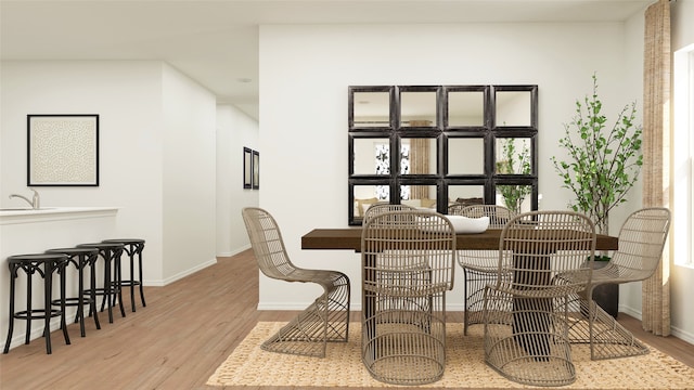 dining room with sink and light hardwood / wood-style floors