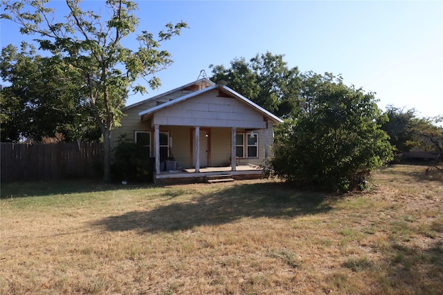 view of front of home featuring covered porch and a front lawn