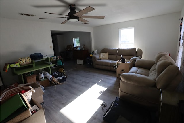 living room with dark hardwood / wood-style floors and ceiling fan