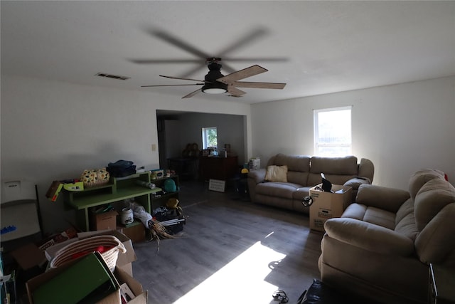 living room with ceiling fan and dark hardwood / wood-style flooring