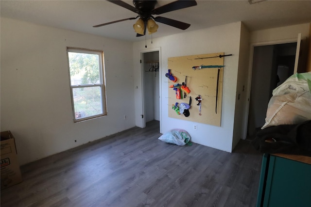 unfurnished bedroom with dark hardwood / wood-style floors and ceiling fan