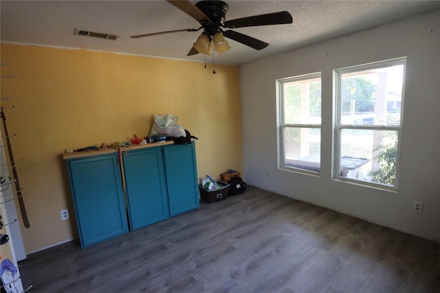 spare room with ceiling fan, dark hardwood / wood-style floors, and a textured ceiling