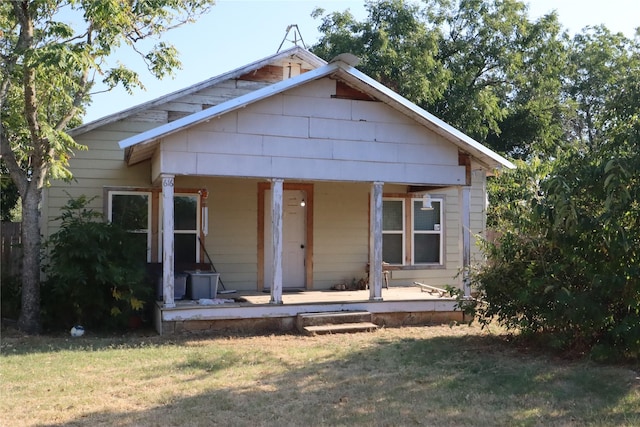 bungalow-style house featuring a front yard