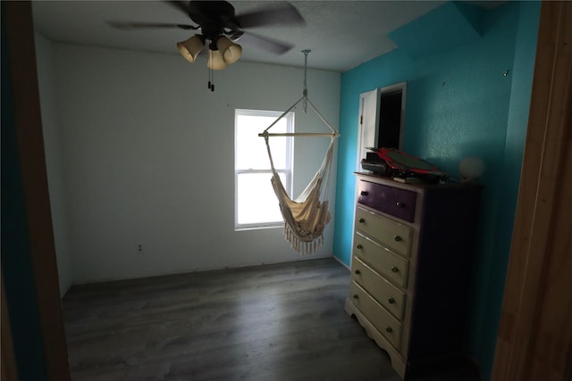 unfurnished bedroom with ceiling fan and wood-type flooring