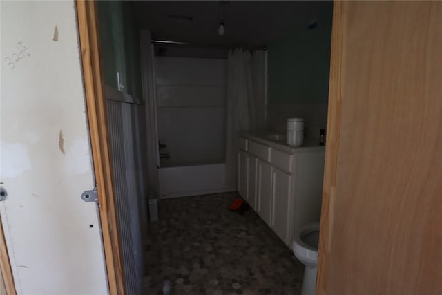 bathroom featuring shower / bath combination with curtain and toilet