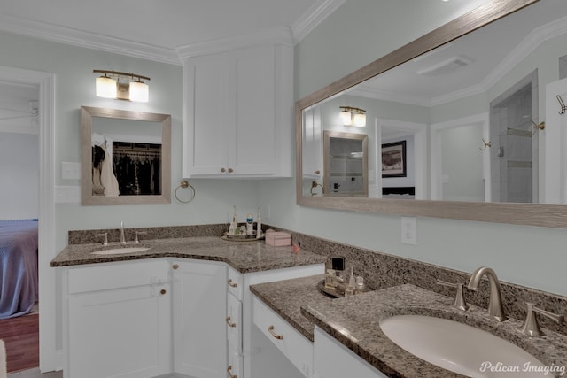 bathroom with vanity, ornamental molding, and walk in shower