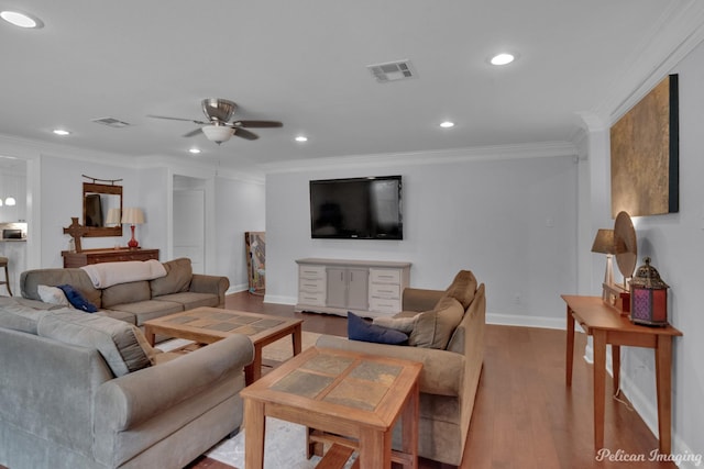 living room featuring ornamental molding, ceiling fan, and light wood-type flooring