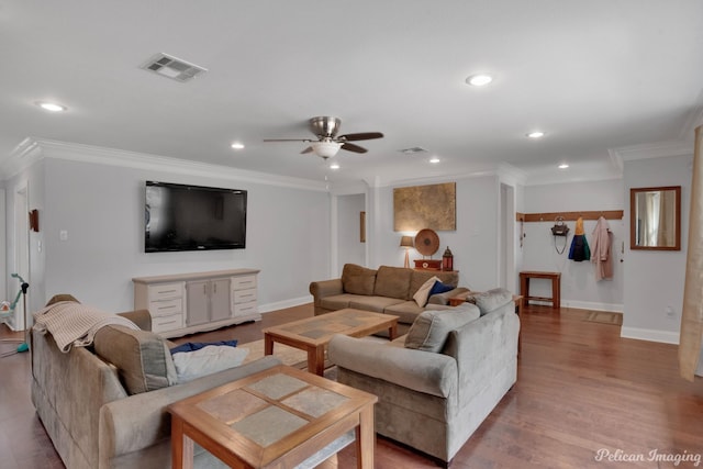 living room featuring crown molding, ceiling fan, and light hardwood / wood-style floors