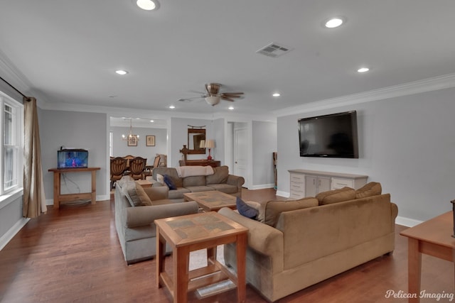 living room featuring crown molding, wood-type flooring, and ceiling fan with notable chandelier