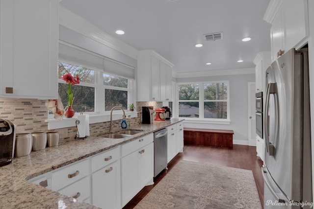 kitchen featuring light stone counters, sink, stainless steel appliances, and white cabinets