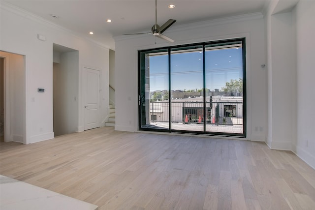 empty room with crown molding, ceiling fan, and light wood-type flooring