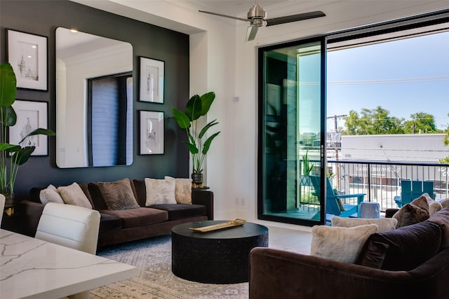 living room featuring ornamental molding and ceiling fan