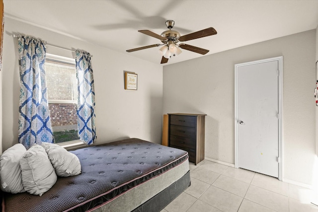 bedroom with ceiling fan and light tile patterned floors