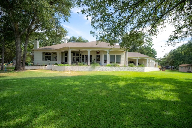 back of property featuring a lawn