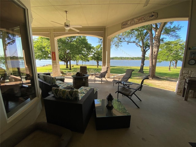 view of patio / terrace featuring an outdoor living space, a water view, and ceiling fan