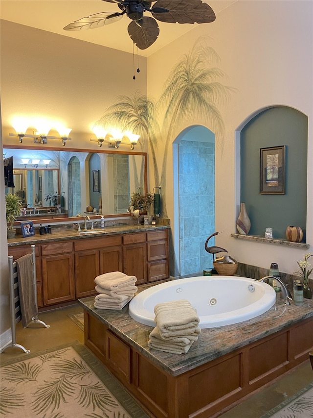 bathroom featuring ceiling fan, vanity, and a tub