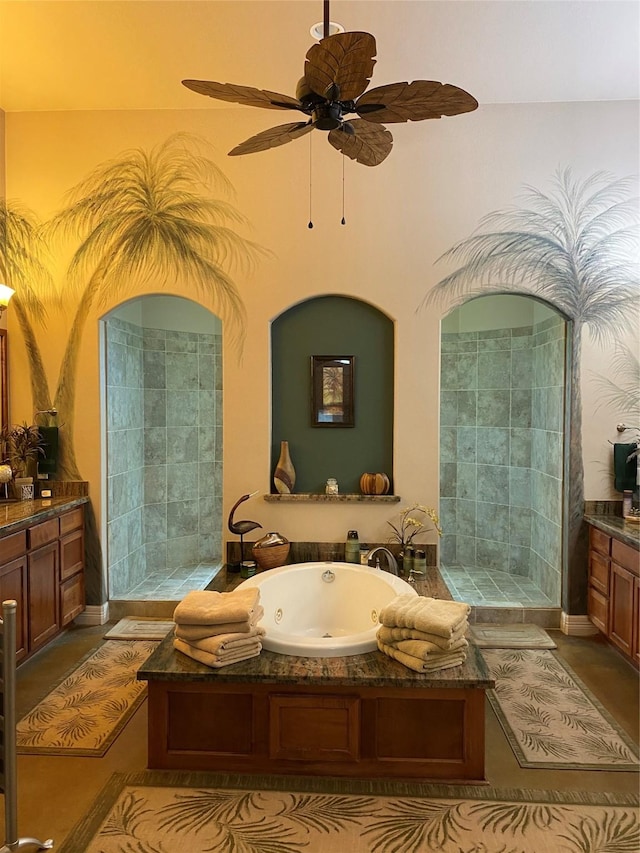 bathroom featuring tile patterned flooring, vanity, a tub, and ceiling fan