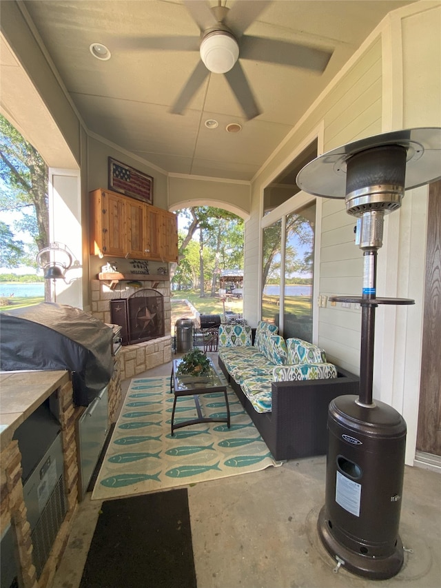 view of patio / terrace with an outdoor living space, ceiling fan, and an outdoor kitchen