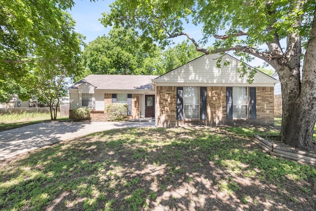 ranch-style home with driveway and brick siding