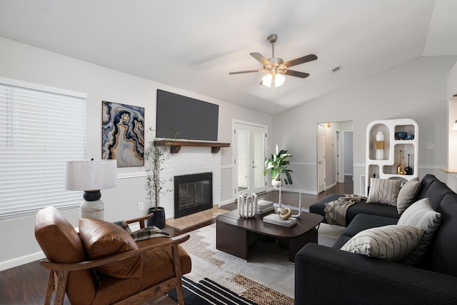 living room featuring a fireplace, wood finished floors, a ceiling fan, baseboards, and vaulted ceiling