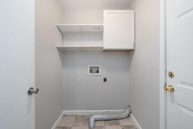 laundry room with cabinets, hookup for a washing machine, hookup for an electric dryer, and a textured ceiling