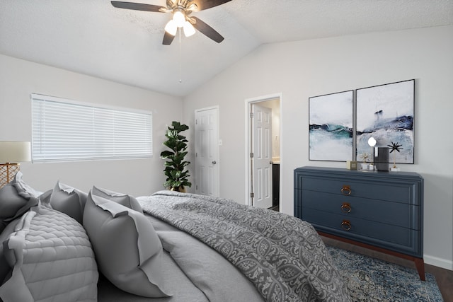 bedroom featuring ceiling fan, lofted ceiling, and a textured ceiling