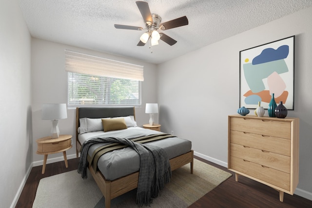 bedroom with ceiling fan, dark wood-type flooring, and a textured ceiling