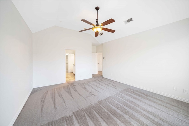 unfurnished bedroom featuring lofted ceiling, light colored carpet, and ceiling fan