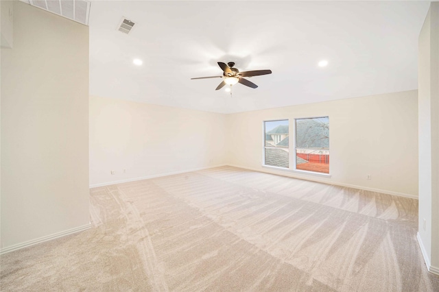 carpeted spare room featuring ceiling fan