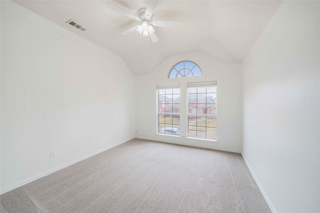 carpeted empty room featuring vaulted ceiling and ceiling fan