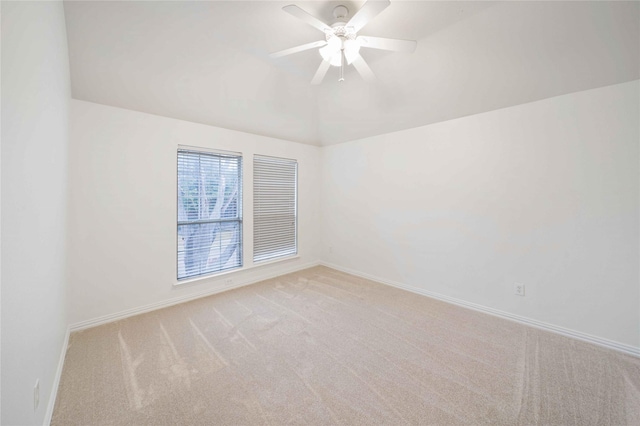 carpeted empty room featuring ceiling fan and vaulted ceiling