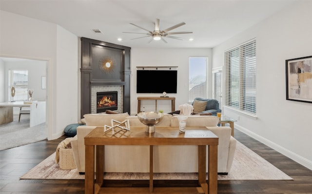 living room with ceiling fan and dark hardwood / wood-style flooring