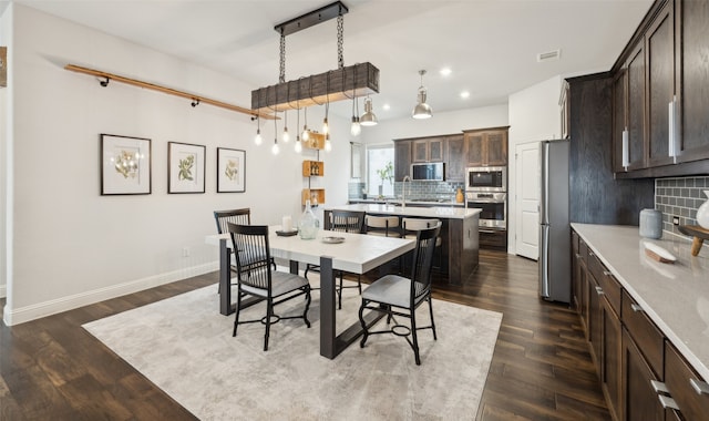 dining area with dark hardwood / wood-style floors