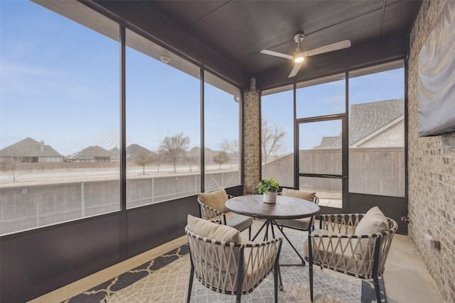 sunroom featuring ceiling fan