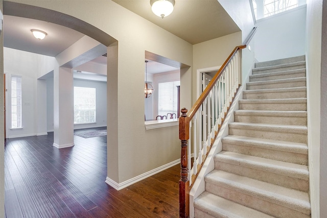 staircase featuring wood-type flooring and plenty of natural light