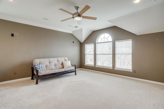 living area featuring ceiling fan, light colored carpet, and vaulted ceiling