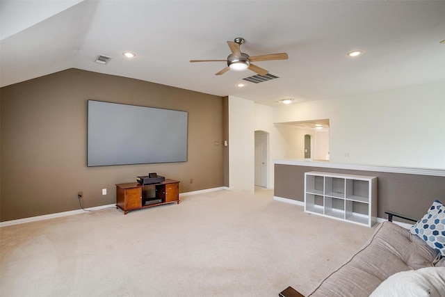 carpeted home theater room with vaulted ceiling and ceiling fan