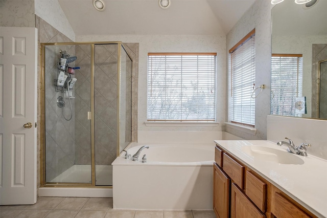 bathroom with tile patterned flooring, vanity, vaulted ceiling, and shower with separate bathtub