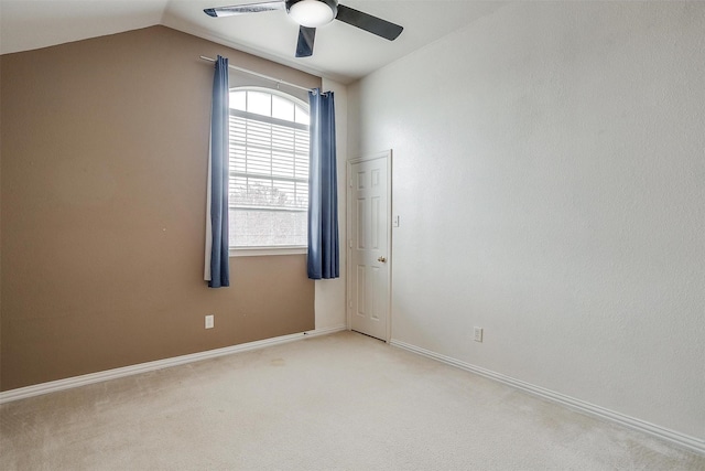 carpeted spare room with lofted ceiling and ceiling fan