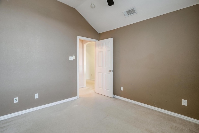 carpeted empty room featuring vaulted ceiling and ceiling fan