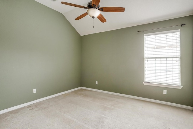 carpeted empty room with lofted ceiling, ceiling fan, and a healthy amount of sunlight