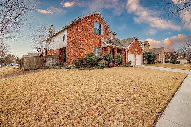 view of front of home with a garage and a front lawn