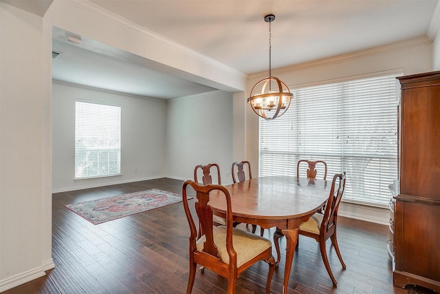 dining room featuring dark wood-type flooring, ornamental molding, plenty of natural light, and an inviting chandelier