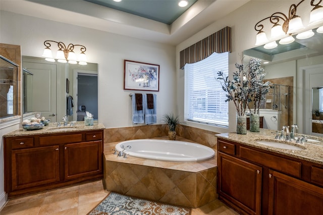 bathroom with vanity, a tray ceiling, tile patterned floors, and shower with separate bathtub