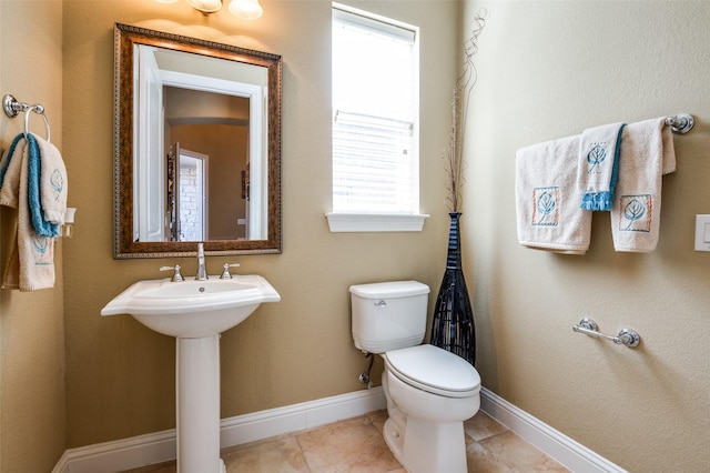 bathroom with tile patterned flooring and toilet