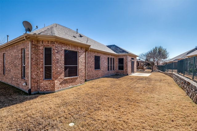 back of property featuring a yard and a patio area