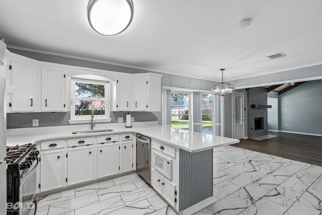 kitchen with sink, range with gas cooktop, decorative light fixtures, dishwasher, and kitchen peninsula