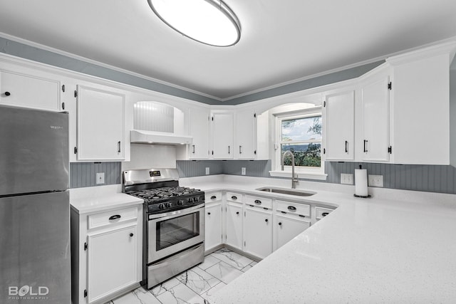 kitchen with white cabinetry, ornamental molding, stainless steel appliances, and sink